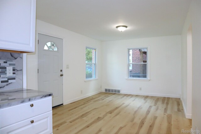 15243 Eastwood St, Detroit, MI 48205 - kitchen featuring light wood finished floors, white cabinetry, and baseboards