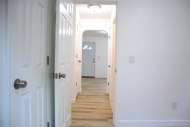 15243 Eastwood St, Detroit, MI 48205 - corridor with light wood-style floors, arched walkways, and baseboards