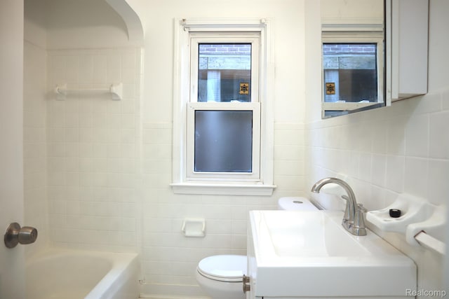 15243 Eastwood St, Detroit, MI 48205 - full bath featuring tile walls, toilet, shower / bathtub combination, and a sink