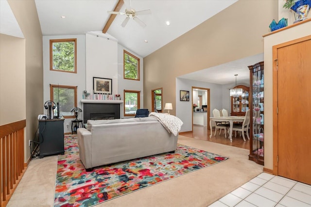 6767 Knollview Dr, Hudsonville, MI 49426 - living area featuring high vaulted ceiling, beamed ceiling, ceiling fan, light carpet, and a fireplace