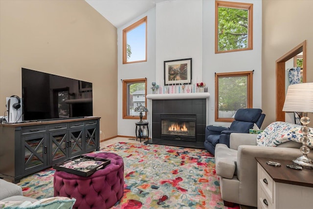 6767 Knollview Dr, Hudsonville, MI 49426 - living room with high vaulted ceiling, healthy amount of natural light, a fireplace, baseboards, and carpet floors