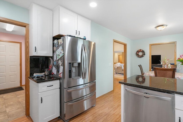 6767 Knollview Dr, Hudsonville, MI 49426 - kitchen with stainless steel appliances, white cabinets, dark stone counters, light wood finished floors, and recessed lighting