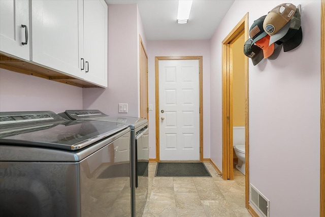 6767 Knollview Dr, Hudsonville, MI 49426 - laundry area with washer and dryer, cabinet space, baseboards, and stone finish flooring