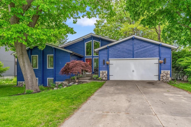 6767 Knollview Dr, Hudsonville, MI 49426 - mid-century modern home with stone siding, concrete driveway, a garage, and a front yard