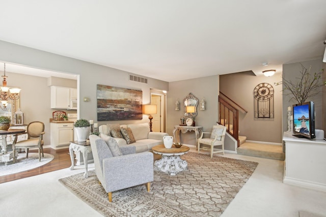 133 Commons Cir, Saline, MI 48176 - living area featuring stairs, a chandelier, carpet floors, and baseboards