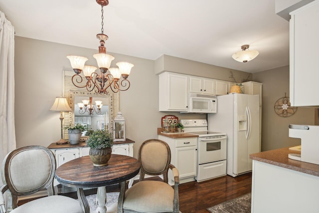 133 Commons Cir, Saline, MI 48176 - kitchen with white appliances, a chandelier, dark wood finished floors, white cabinetry, and decorative light fixtures