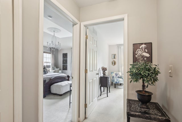 133 Commons Cir, Saline, MI 48176 - hallway featuring carpet floors and a chandelier