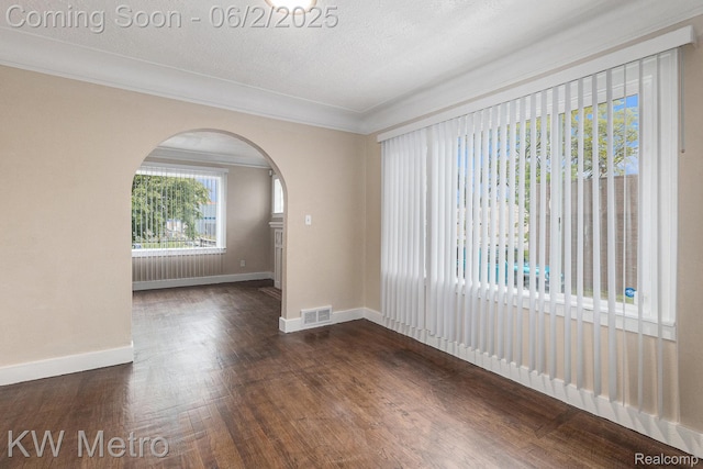 5025 Somerset Ave, Detroit, MI 48224 - unfurnished room with arched walkways, baseboards, dark wood-style floors, and crown molding