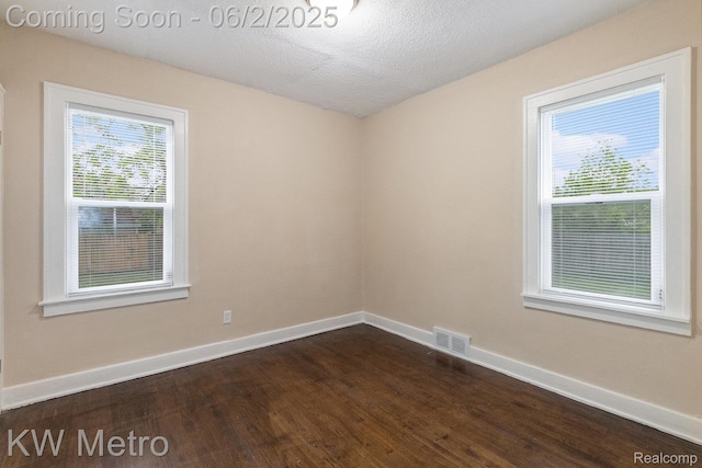 5025 Somerset Ave, Detroit, MI 48224 - empty room featuring dark wood-style flooring, baseboards, and a textured ceiling
