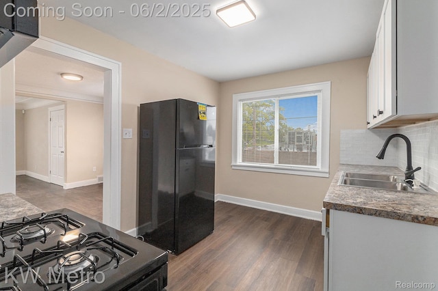 5025 Somerset Ave, Detroit, MI 48224 - kitchen with freestanding refrigerator, a sink, range with gas cooktop, white cabinets, and dark wood-style floors