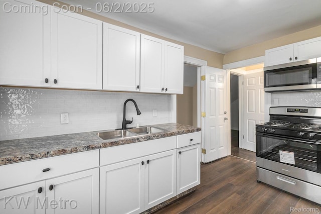 5025 Somerset Ave, Detroit, MI 48224 - kitchen with appliances with stainless steel finishes, a sink, dark wood finished floors, and white cabinetry