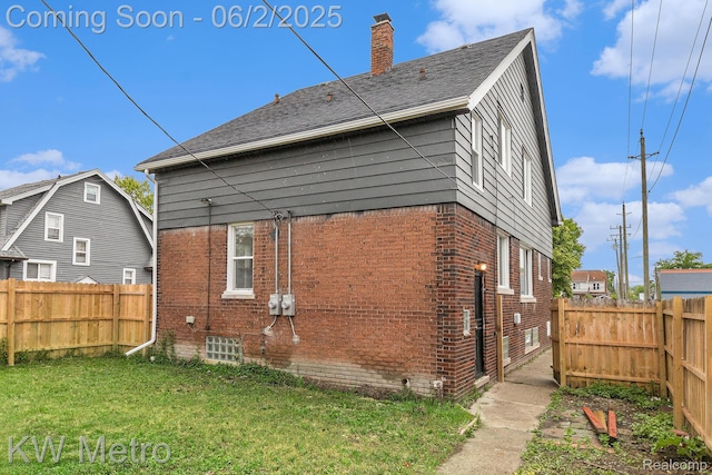 5025 Somerset Ave, Detroit, MI 48224 - back of house featuring brick siding, a chimney, and roof with shingles