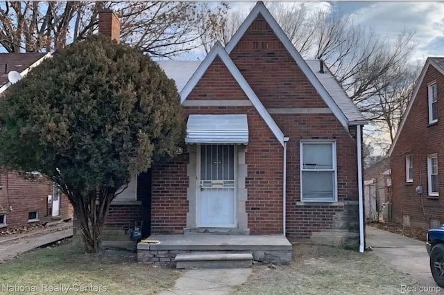 8227 Coyle St, Detroit, MI 48228 - view of front of property with brick siding and a chimney