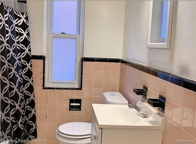 8227 Coyle St, Detroit, MI 48228 - full bath featuring tile walls, toilet, a shower with curtain, a wainscoted wall, and vanity