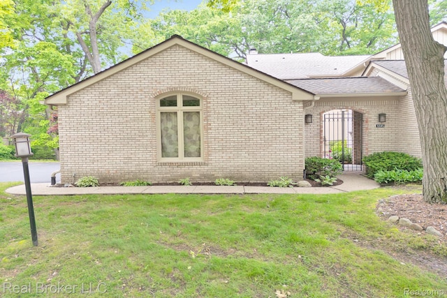 1285 Greenglen Ct, Bloomfield Hills, MI 48304 - view of side of home with brick siding, a yard, a shingled roof, and a chimney