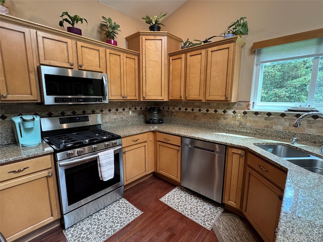 47151 Admirals Cove Ln Unit 1, Chesterfield, MI 48051 - kitchen featuring appliances with stainless steel finishes, a sink, dark wood-style flooring, backsplash, and light stone countertops