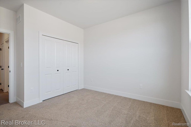 35704 Addison Dr, New Baltimore, MI 48047 - unfurnished bedroom featuring light colored carpet, baseboards, and a closet
