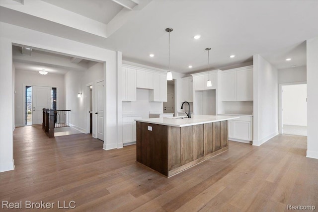 35704 Addison Dr, New Baltimore, MI 48047 - kitchen featuring a sink, a kitchen island with sink, light wood-type flooring, white cabinets, and recessed lighting