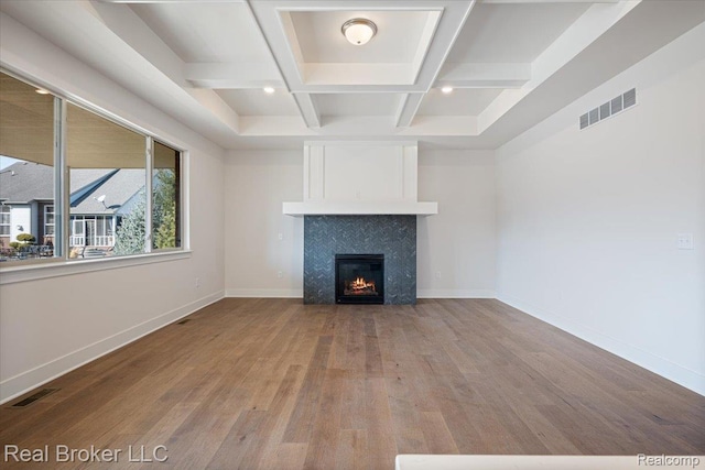 35704 Addison Dr, New Baltimore, MI 48047 - unfurnished living room with wood finished floors, coffered ceiling, beam ceiling, baseboards, and a tiled fireplace