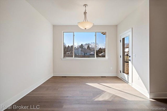 35704 Addison Dr, New Baltimore, MI 48047 - unfurnished dining area with wood finished floors and baseboards