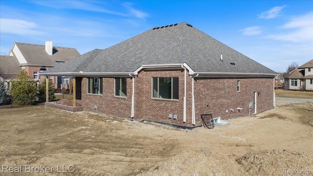 35704 Addison Dr, New Baltimore, MI 48047 - rear view of property featuring brick siding and roof with shingles