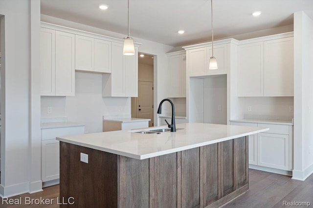 35704 Addison Dr, New Baltimore, MI 48047 - kitchen with a sink, a center island with sink, white cabinetry, dark wood-type flooring, and decorative light fixtures