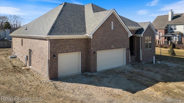 35704 Addison Dr, New Baltimore, MI 48047 - view of side of home with brick siding, a shingled roof, and dirt driveway