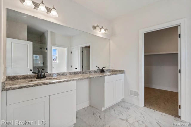 35704 Addison Dr, New Baltimore, MI 48047 - bathroom featuring double vanity, tiled shower, baseboards, and marble finish floors