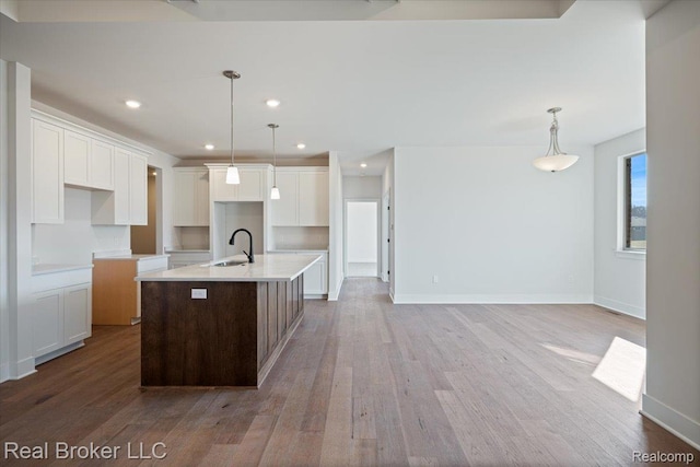 35704 Addison Dr, New Baltimore, MI 48047 - kitchen with a sink, an island with sink, light wood-style floors, white cabinets, and recessed lighting