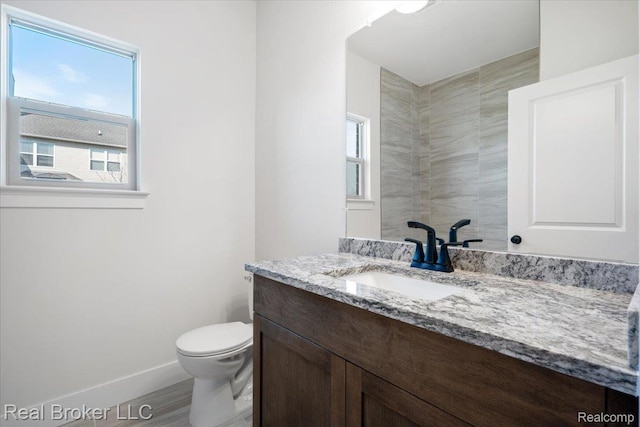 35704 Addison Dr, New Baltimore, MI 48047 - bathroom featuring vanity, baseboards, toilet, and wood finished floors