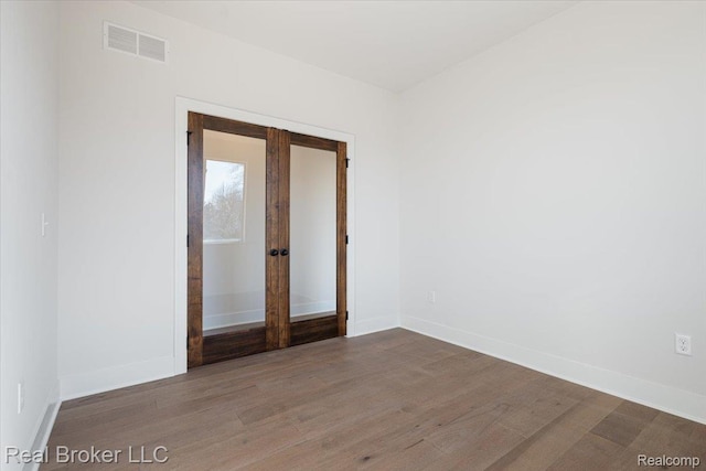 35704 Addison Dr, New Baltimore, MI 48047 - empty room with baseboards, french doors, and wood finished floors