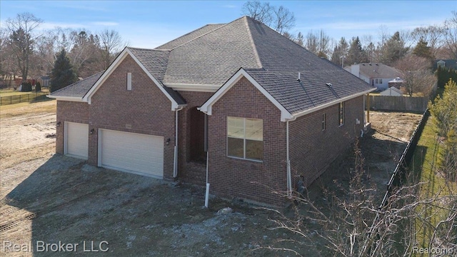 35704 Addison Dr, New Baltimore, MI 48047 - view of front facade with brick siding, driveway, a shingled roof, and a garage