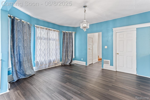5839 Mcmillan St, Allen Park, MI 48209 - empty room featuring a chandelier, wood finished floors, and baseboards