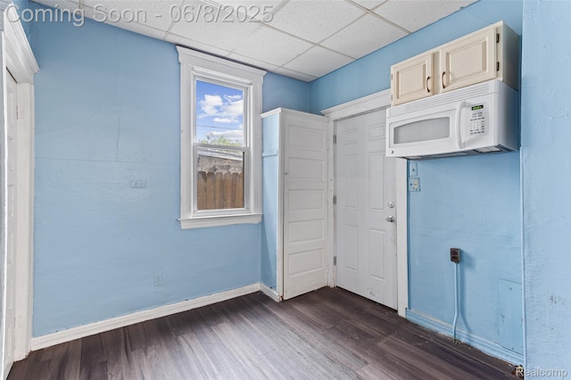 5839 Mcmillan St, Allen Park, MI 48209 - unfurnished bedroom featuring dark wood finished floors, baseboards, and a drop ceiling