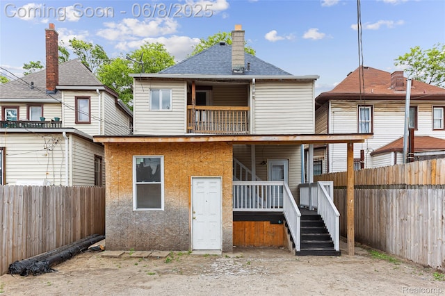 5839 Mcmillan St, Allen Park, MI 48209 - back of property featuring a balcony, a fenced backyard, a chimney, and a shingled roof