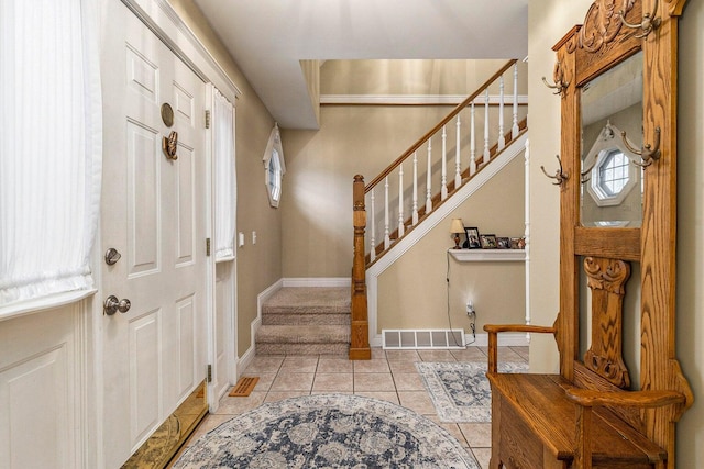 3313 Gethings Rd, Battle Creek, MI 49015 - foyer with stairway, light tile patterned flooring, and baseboards