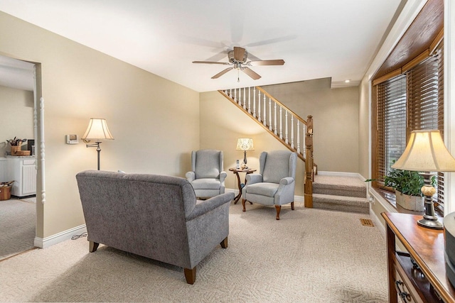 3313 Gethings Rd, Battle Creek, MI 49015 - living room with light colored carpet, stairs, ceiling fan, and baseboards