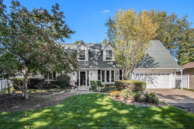 3313 Gethings Rd, Battle Creek, MI 49015 - cape cod-style house with an attached garage, driveway, and roof with shingles