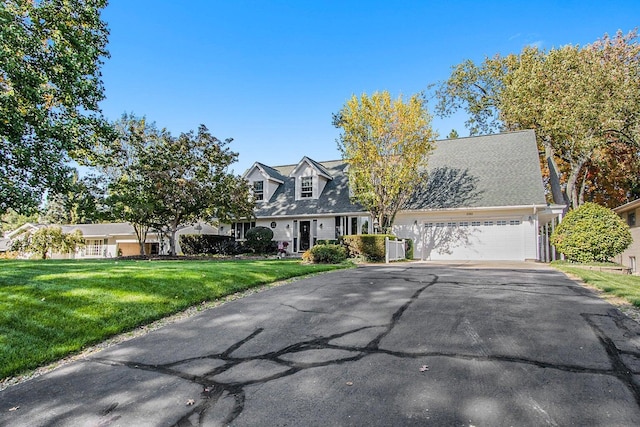 3313 Gethings Rd, Battle Creek, MI 49015 - new england style home featuring driveway, an attached garage, a front lawn, and cooling unit