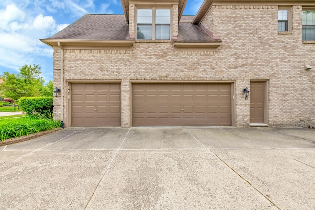 482 Torrington Dr W, Canton, MI 48188 - view of front of home with concrete driveway, brick siding, a garage, and roof with shingles
