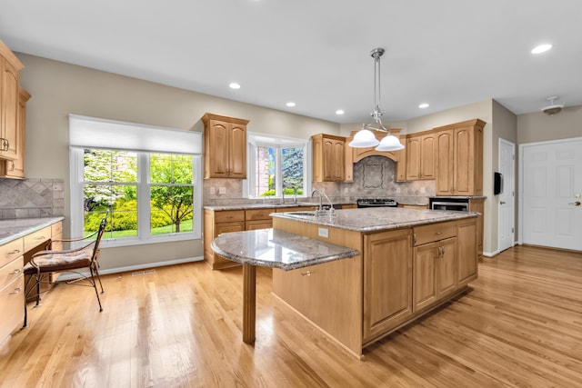 482 Torrington Dr W, Canton, MI 48188 - kitchen with a center island with sink, light wood finished floors, tasteful backsplash, gas range, and recessed lighting