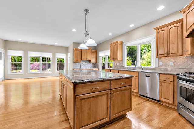 482 Torrington Dr W, Canton, MI 48188 - kitchen with stainless steel appliances, healthy amount of natural light, light wood-style floors, light stone countertops, and recessed lighting
