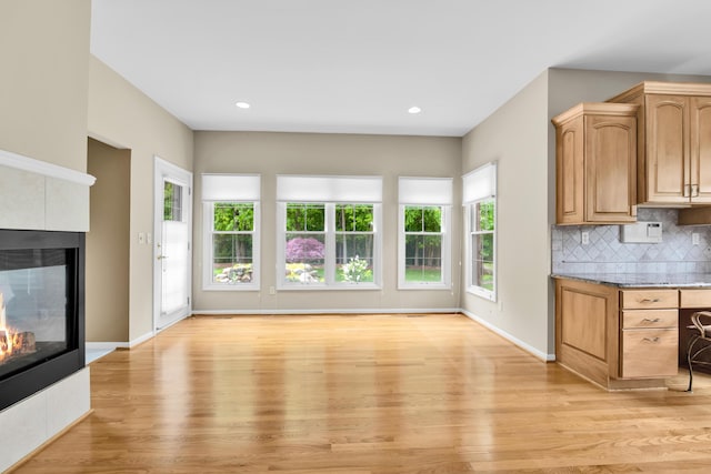 482 Torrington Dr W, Canton, MI 48188 - kitchen featuring light wood-style flooring, a multi sided fireplace, decorative backsplash, baseboards, and recessed lighting