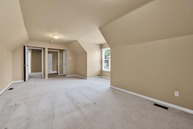 482 Torrington Dr W, Canton, MI 48188 - additional living space with vaulted ceiling, light carpet, and baseboards