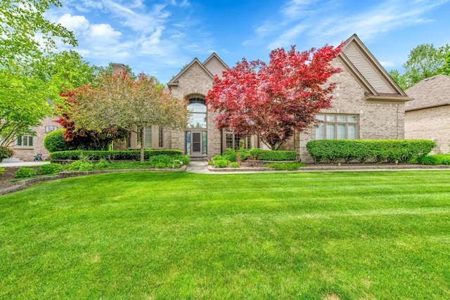 482 Torrington Dr W, Canton, MI 48188 - french country style house featuring a front lawn and brick siding