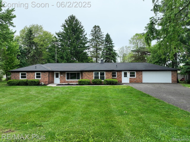 1022 Turrill Rd, Lapeer, MI 48446 - ranch-style house featuring a garage, asphalt driveway, brick siding, and a front yard