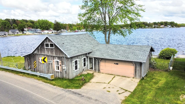 10920 Dwight St, Chippewa Lake, MI 49320 - view of front of property with driveway, a water view, a garage, and roof with shingles