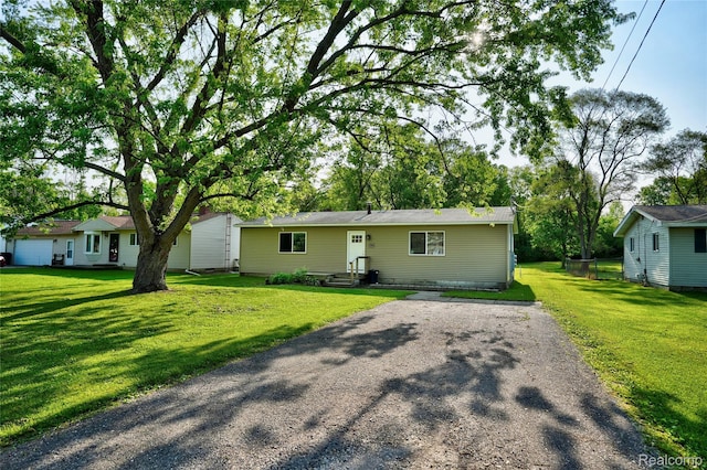 2243 Noble Ave, Flint, MI 48532 - view of front facade featuring a front lawn and asphalt driveway