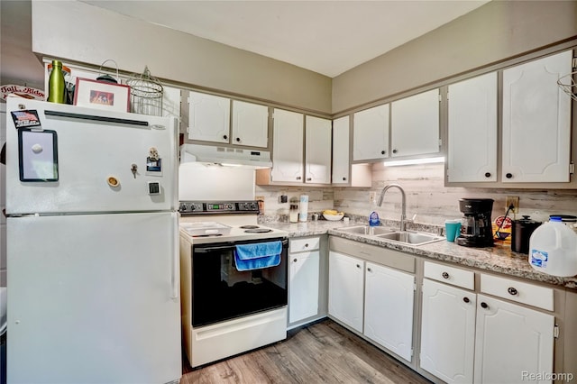 2243 Noble Ave, Flint, MI 48532 - kitchen with white appliances, under cabinet range hood, white cabinets, light countertops, and tasteful backsplash