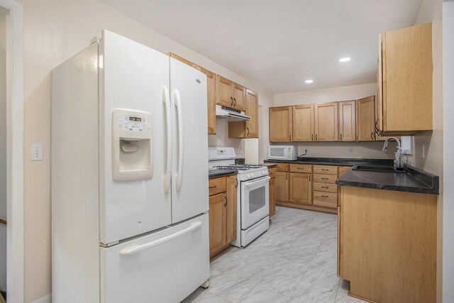 2013 Cumberland St, Kalamazoo, MI 49006 - kitchen with white appliances, dark countertops, under cabinet range hood, recessed lighting, and a sink